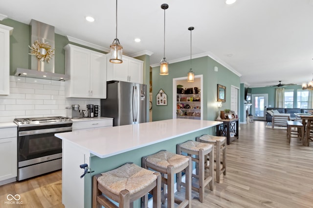 19959 Cowie Ln, Westfield, IN 46074 - kitchen with appliances with stainless steel finishes, wall chimney range hood, tasteful backsplash, light wood-style flooring, and light countertops