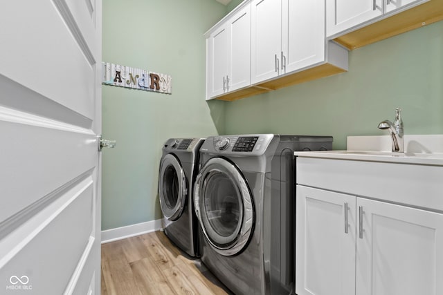 19959 Cowie Ln, Westfield, IN 46074 - laundry room featuring cabinet space, washing machine and dryer, and light wood finished floors