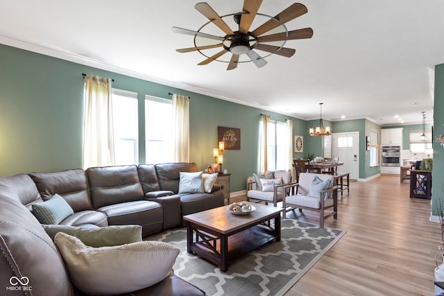 19959 Cowie Ln, Westfield, IN 46074 - living area featuring a chandelier, ceiling fan, crown molding, and light wood-style flooring