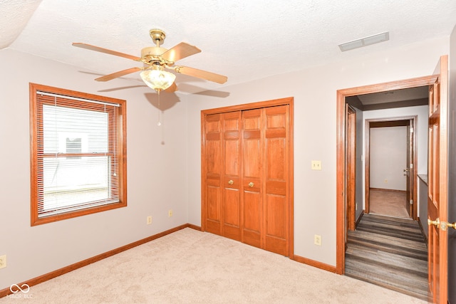 662 Leah Way, Greenwood, IN 46142 - unfurnished bedroom with carpet, a closet, a textured ceiling, and ceiling fan