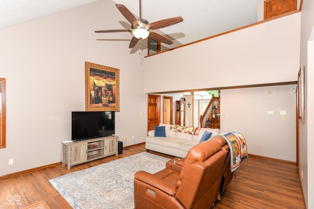 662 Leah Way, Greenwood, IN 46142 - living room featuring high vaulted ceiling, ceiling fan, wood finished floors, and stairs