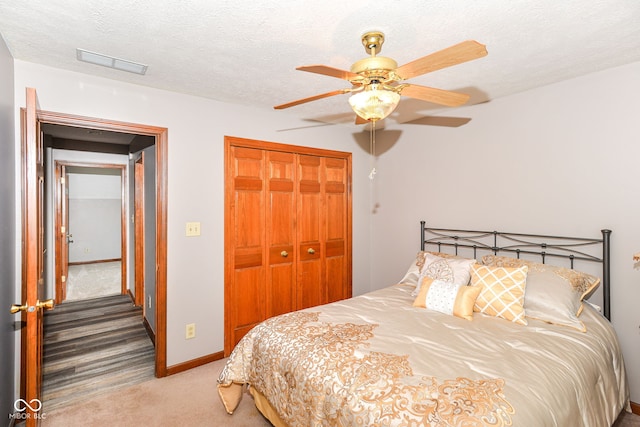 662 Leah Way, Greenwood, IN 46142 - bedroom featuring carpet, a closet, a textured ceiling, and ceiling fan