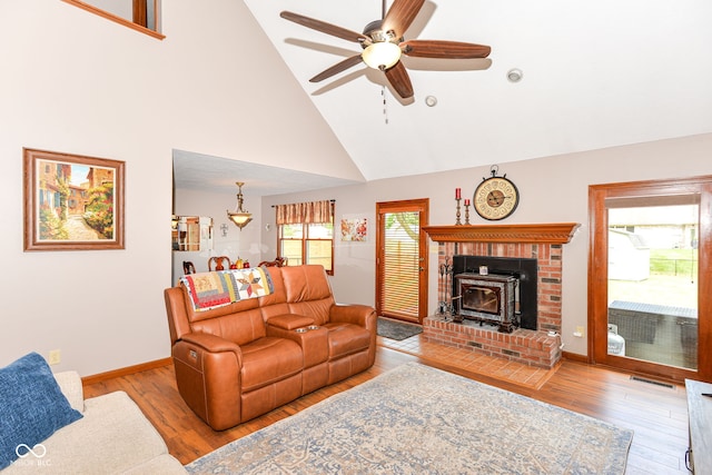 662 Leah Way, Greenwood, IN 46142 - living area featuring high vaulted ceiling, wood finished floors, a ceiling fan, and a wood stove