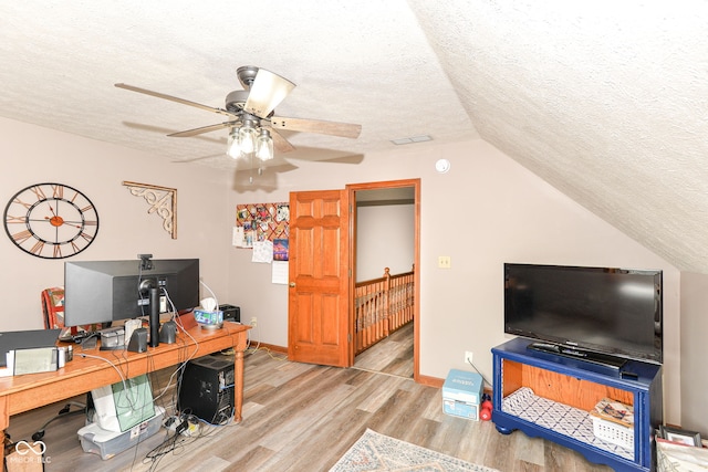 662 Leah Way, Greenwood, IN 46142 - home office with a textured ceiling, wood finished floors, ceiling fan, and vaulted ceiling