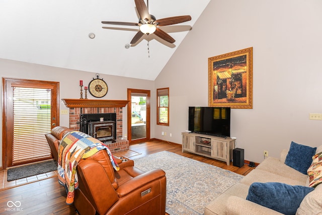 662 Leah Way, Greenwood, IN 46142 - living room with high vaulted ceiling, wood finished floors, a brick fireplace, and ceiling fan