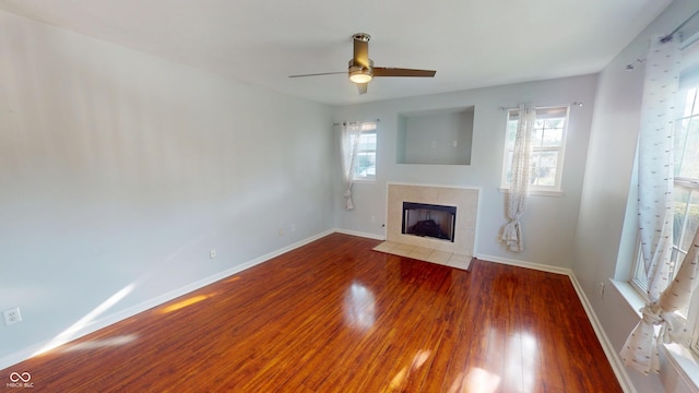 2259 Colfax Ln Unit 2259, Indianapolis, IN 46260 - unfurnished living room featuring a fireplace, wood finished floors, plenty of natural light, and ceiling fan