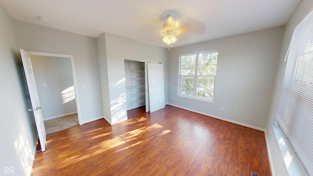 2259 Colfax Ln Unit 2259, Indianapolis, IN 46260 - unfurnished bedroom featuring a closet, wood finished floors, and a ceiling fan