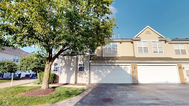 2259 Colfax Ln Unit 2259, Indianapolis, IN 46260 - multi unit property with driveway, an attached garage, and brick siding