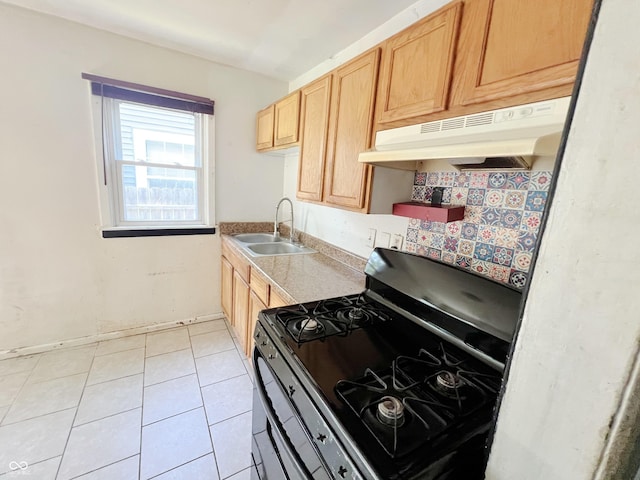 1601 E 44th St, Indianapolis, IN 46205 - kitchen featuring stainless steel gas stove, under cabinet range hood, light tile patterned floors, light brown cabinetry, and light countertops
