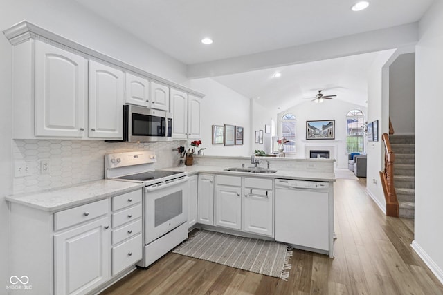 16636 Brownstone Ct, Westfield, IN 46074 - kitchen with white appliances, a peninsula, wood finished floors, ceiling fan, and vaulted ceiling