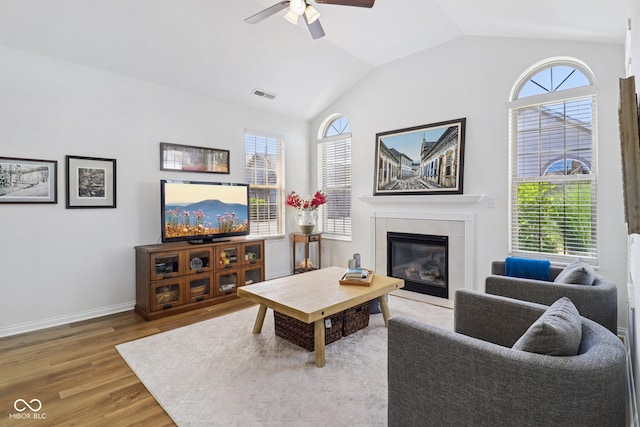 16636 Brownstone Ct, Westfield, IN 46074 - living area featuring wood finished floors, a tile fireplace, a ceiling fan, and lofted ceiling