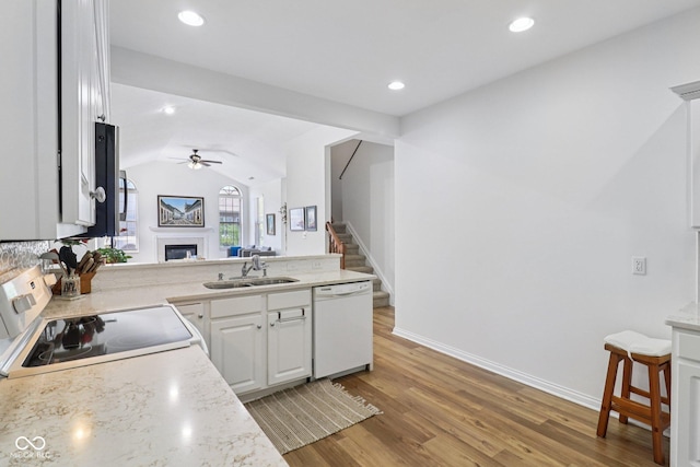 16636 Brownstone Ct, Westfield, IN 46074 - kitchen with white appliances, a ceiling fan, a fireplace, light wood-style floors, and vaulted ceiling