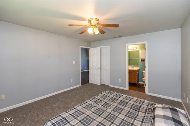 142 Hilltop Farms Blvd, Whiteland, IN 46184 - unfurnished bedroom featuring dark colored carpet, ensuite bathroom, and ceiling fan