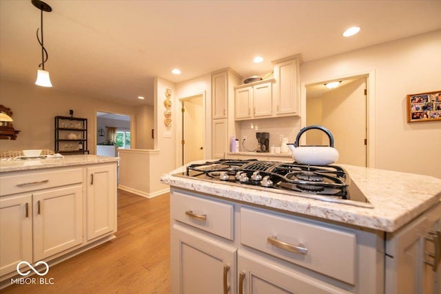 8550 Tidewater Ct, Indianapolis, IN 46236 - kitchen featuring stainless steel gas stovetop, light wood-style flooring, decorative light fixtures, recessed lighting, and light stone countertops