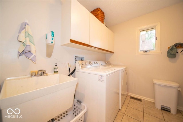 8550 Tidewater Ct, Indianapolis, IN 46236 - laundry room with washing machine and dryer, cabinet space, and light tile patterned flooring