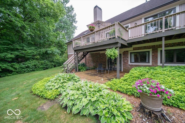 8550 Tidewater Ct, Indianapolis, IN 46236 - rear view of property featuring a wooden deck, brick siding, stairway, a patio area, and a chimney