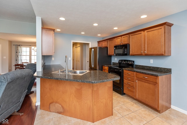 1977 Sophia Ln, Seymour, IN 47274 - kitchen featuring black appliances, a peninsula, brown cabinets, open floor plan, and recessed lighting