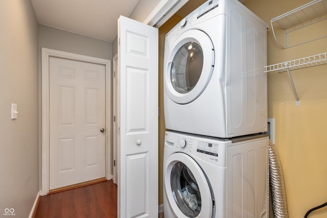 1977 Sophia Ln, Seymour, IN 47274 - laundry room featuring stacked washer / drying machine and wood finished floors