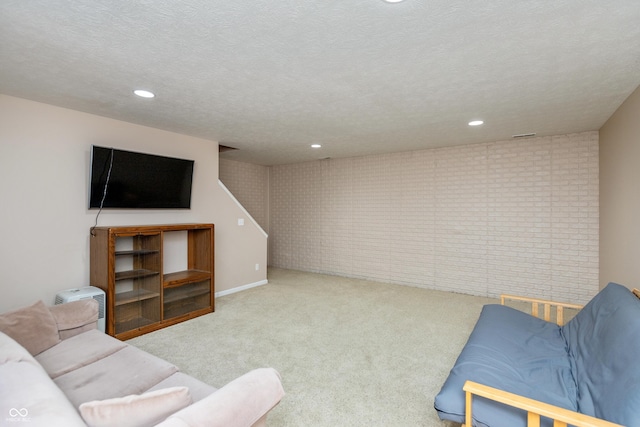 1977 Sophia Ln, Seymour, IN 47274 - carpeted living area with recessed lighting, brick wall, and a textured ceiling
