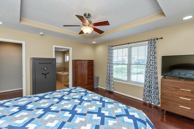 1977 Sophia Ln, Seymour, IN 47274 - bedroom featuring a tray ceiling, wood finished floors, connected bathroom, a ceiling fan, and recessed lighting