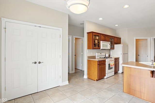 35 Decourcy Ln, Franklin, IN 46131 - kitchen featuring white appliances, light countertops, glass insert cabinets, light tile patterned floors, and recessed lighting