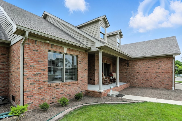 35 Decourcy Ln, Franklin, IN 46131 - entrance to property featuring brick siding, a shingled roof, and a patio area