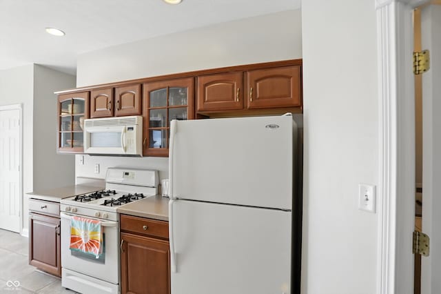 35 Decourcy Ln, Franklin, IN 46131 - kitchen featuring white appliances, glass insert cabinets, light countertops, brown cabinetry, and recessed lighting