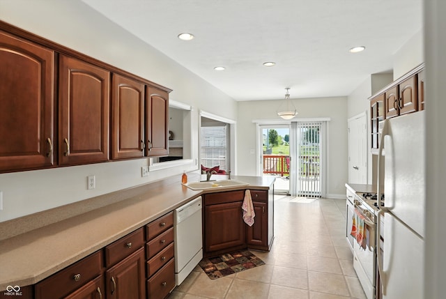 35 Decourcy Ln, Franklin, IN 46131 - kitchen with white appliances, a peninsula, light tile patterned floors, recessed lighting, and pendant lighting