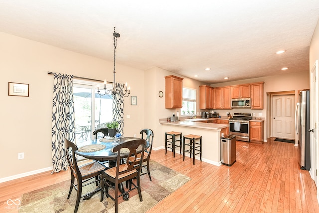 11820 Stepping Stone Dr, Fishers, IN 46037 - dining space featuring a chandelier, light wood finished floors, recessed lighting, and healthy amount of natural light