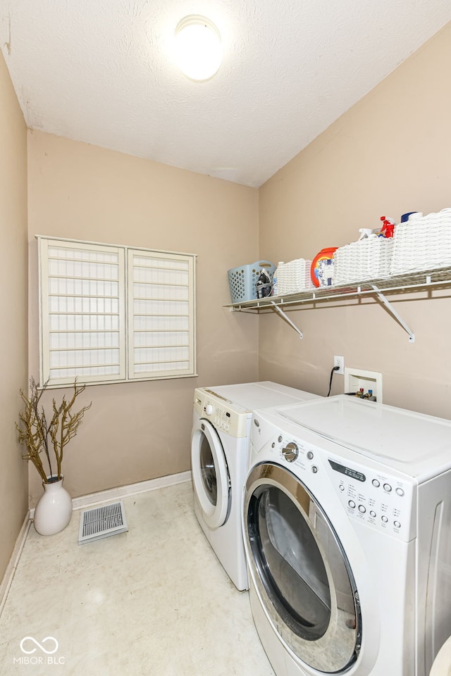 11820 Stepping Stone Dr, Fishers, IN 46037 - laundry area featuring washing machine and clothes dryer and baseboards