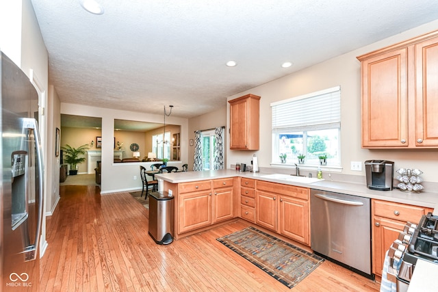 11820 Stepping Stone Dr, Fishers, IN 46037 - kitchen featuring stainless steel appliances, a peninsula, light wood-style floors, light countertops, and recessed lighting