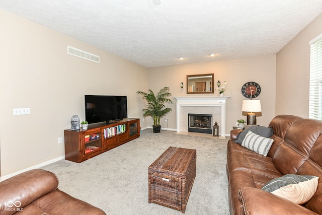 11820 Stepping Stone Dr, Fishers, IN 46037 - living room with carpet, a textured ceiling, a tiled fireplace, and recessed lighting