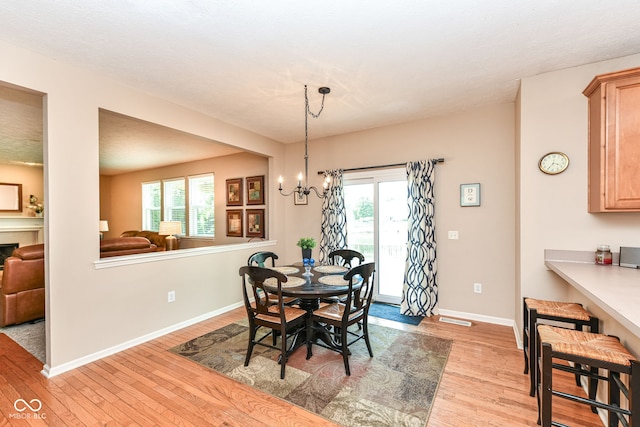 11820 Stepping Stone Dr, Fishers, IN 46037 - dining room featuring light wood-style floors, a chandelier, and plenty of natural light