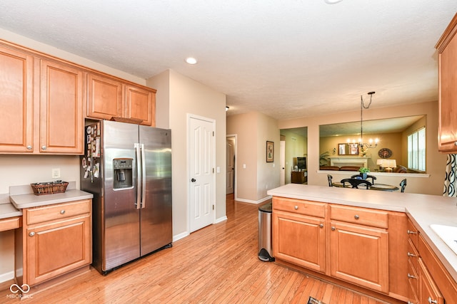 11820 Stepping Stone Dr, Fishers, IN 46037 - kitchen featuring stainless steel refrigerator with ice dispenser, light wood-style floors, light countertops, a peninsula, and recessed lighting