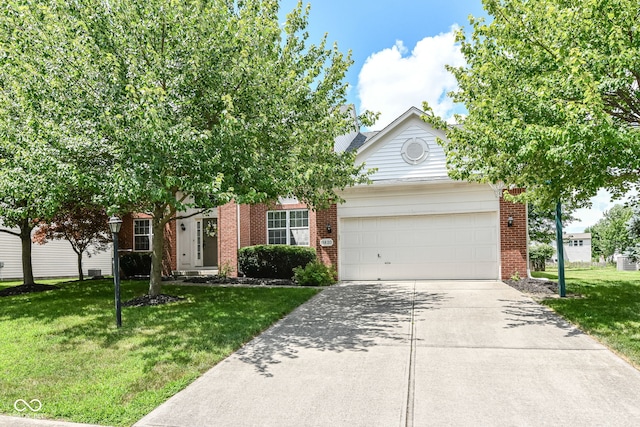 11820 Stepping Stone Dr, Fishers, IN 46037 - obstructed view of property with a garage, brick siding, and a front yard