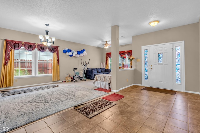 1449 Danielle Dr, Indianapolis, IN 46231 - tiled foyer featuring healthy amount of natural light, a textured ceiling, a chandelier, and a ceiling fan