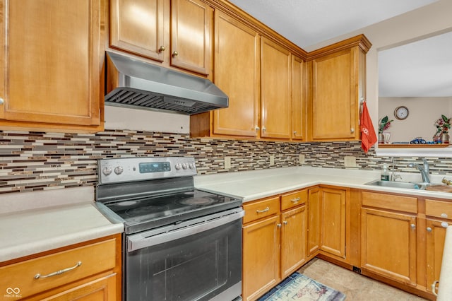 1449 Danielle Dr, Indianapolis, IN 46231 - kitchen with stainless steel electric range oven, under cabinet range hood, backsplash, and light countertops