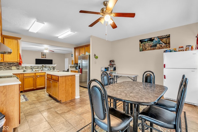 1449 Danielle Dr, Indianapolis, IN 46231 - kitchen featuring freestanding refrigerator, a ceiling fan, light countertops, stainless steel refrigerator with ice dispenser, and a kitchen island