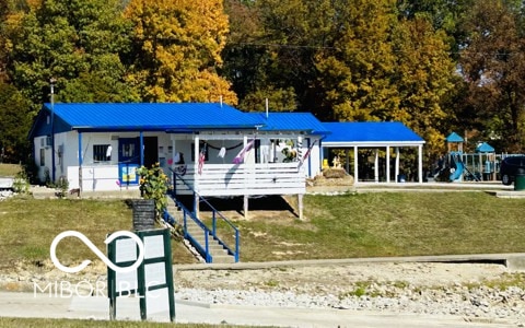 339 Honey Locust Pl, North Vernon, IN 47265 - view of front of property with a front yard, a metal roof, and a deck