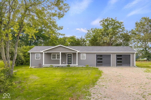 339 Honey Locust Pl, North Vernon, IN 47265 - view of front of house with dirt driveway, a porch, a front yard, and an attached garage