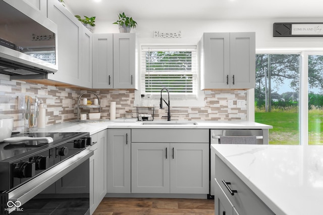 339 Honey Locust Pl, North Vernon, IN 47265 - kitchen featuring stainless steel microwave, stove, decorative backsplash, and light stone countertops