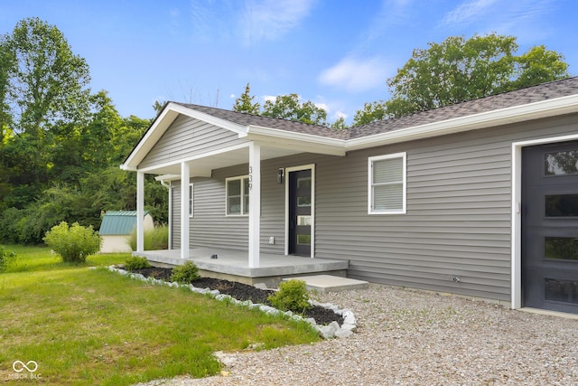 339 Honey Locust Pl, North Vernon, IN 47265 - view of front of home featuring covered porch, roof with shingles, and a front yard