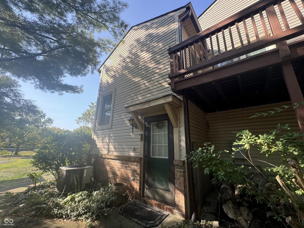 9552 Maple Way, Indianapolis, IN 46268 - view of side of property featuring a central AC unit and brick siding