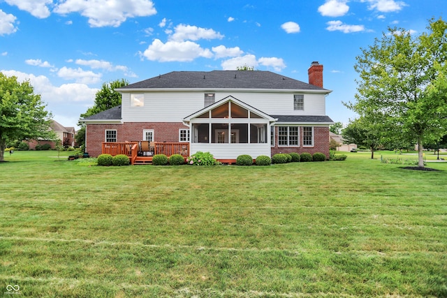 5761 Coopers Hawk Dr, Carmel, IN 46033 - back of house with brick siding, a sunroom, a chimney, and a yard
