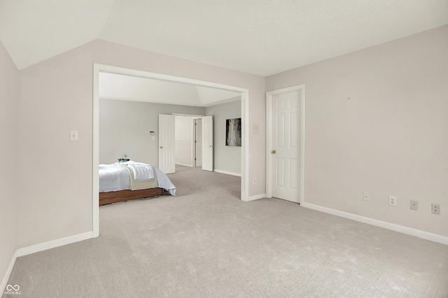 5761 Coopers Hawk Dr, Carmel, IN 46033 - carpeted bedroom with baseboards and lofted ceiling