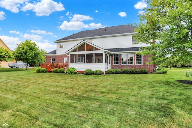 5761 Coopers Hawk Dr, Carmel, IN 46033 - rear view of house featuring a sunroom, a lawn, brick siding, and a wooden deck