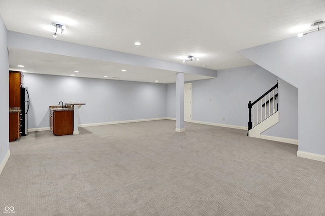 2263 Glebe St, Carmel, IN 46032 - finished basement with light colored carpet, bar with sink, stairs, recessed lighting, and freestanding refrigerator