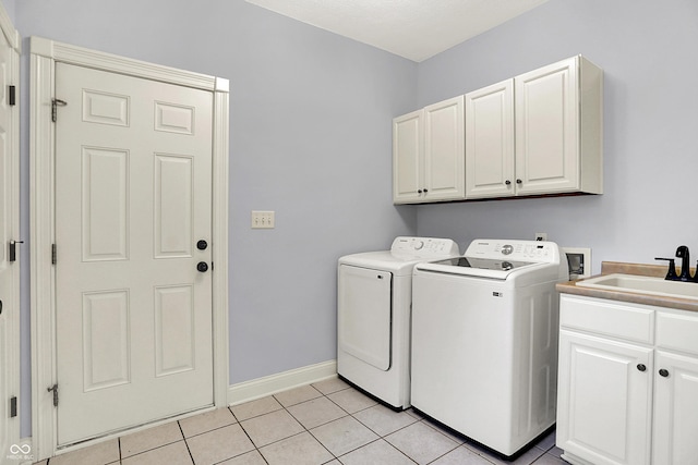 2263 Glebe St, Carmel, IN 46032 - laundry area featuring cabinet space, washer and clothes dryer, and light tile patterned floors