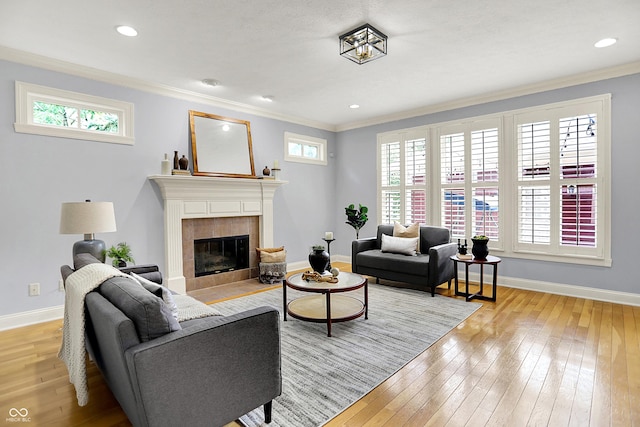 2263 Glebe St, Carmel, IN 46032 - living area with light wood-style floors, a fireplace, ornamental molding, healthy amount of natural light, and recessed lighting