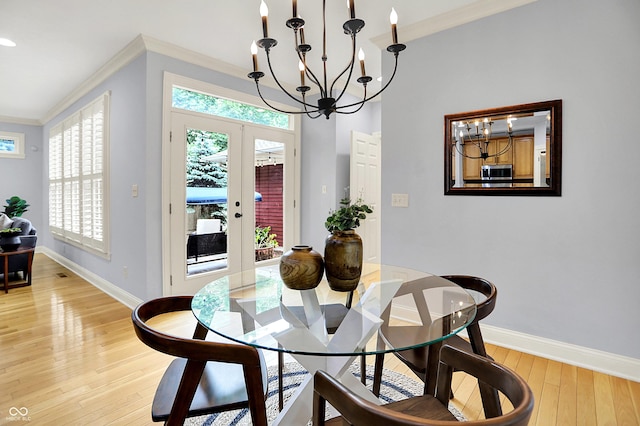 2263 Glebe St, Carmel, IN 46032 - dining space with a chandelier, ornamental molding, light wood-style floors, and french doors